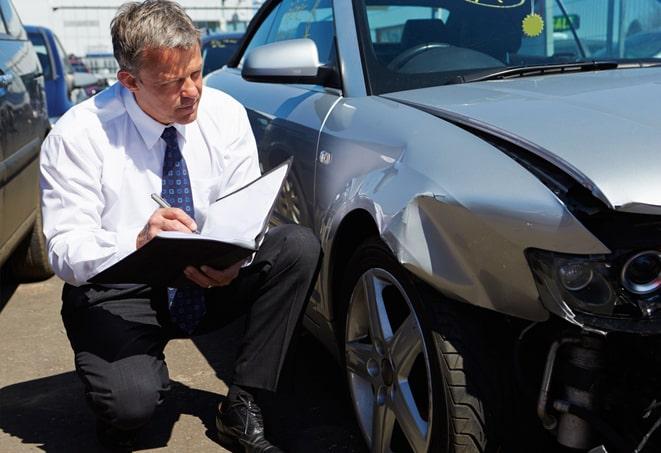 car insurance policy document with pen and keys